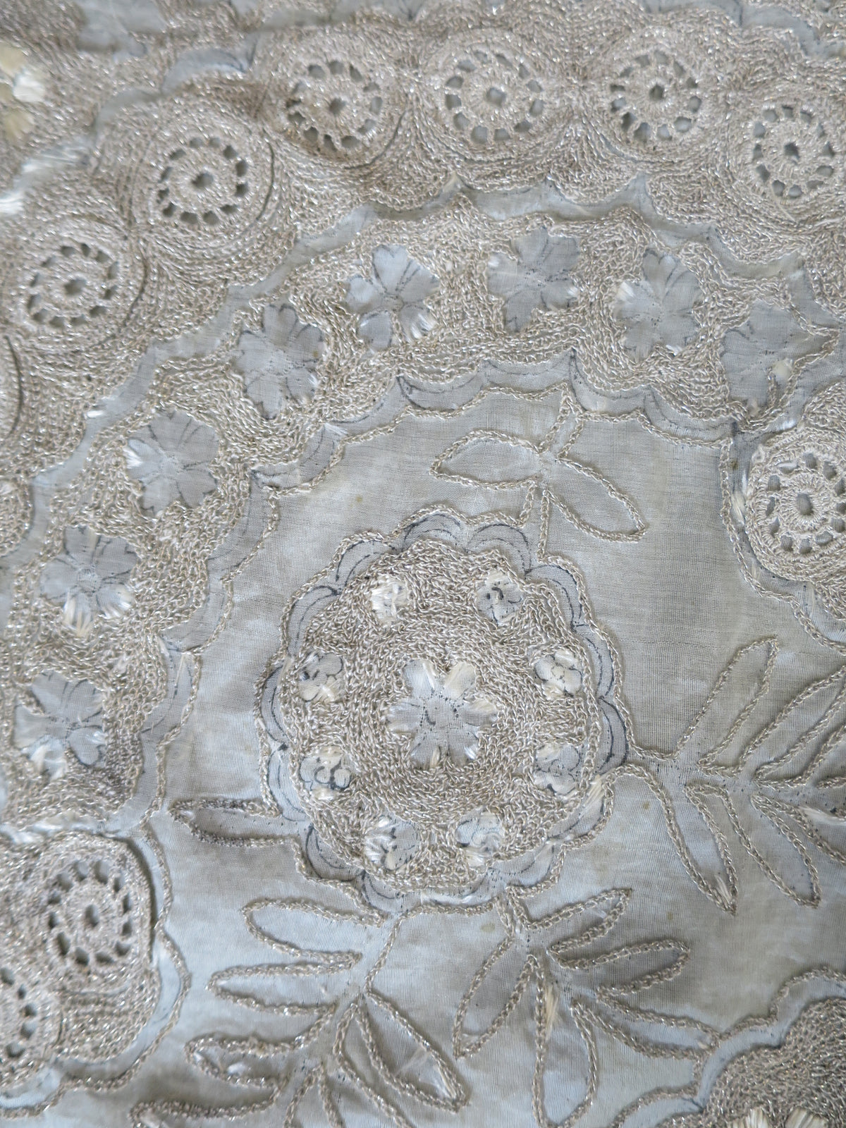 Rare original 19th-century artisan ink design tracings revealed under worn silk embroidery on an antique Zardozi panel.