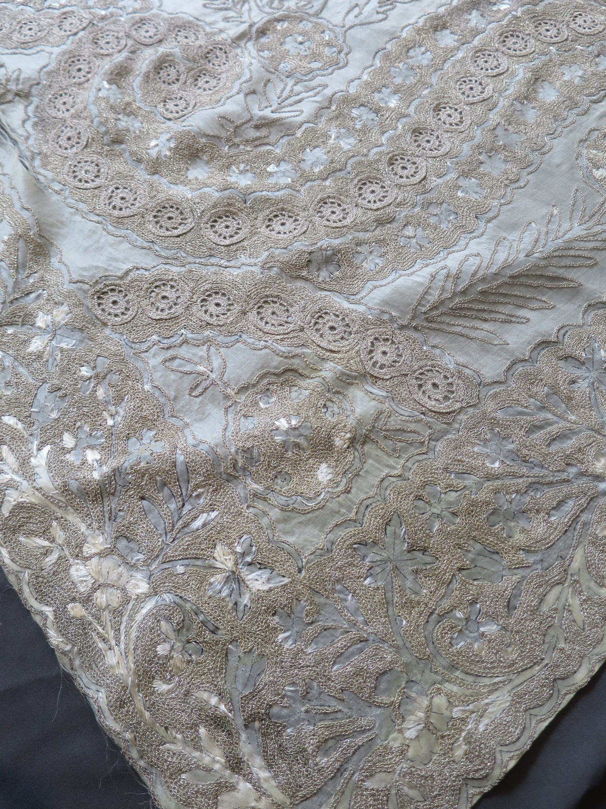 Rare original 19th-century artisan ink design tracings revealed under worn silk embroidery on an antique Zardozi panel.