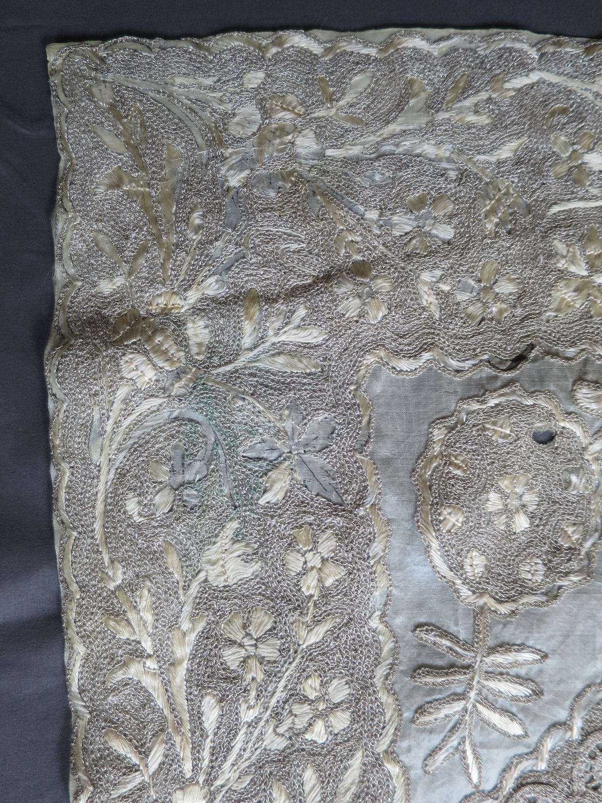 Small spots of green verdigris copper oxidization on the genuine gilt-copper wire of a vintage Indian metal embroidery panel.