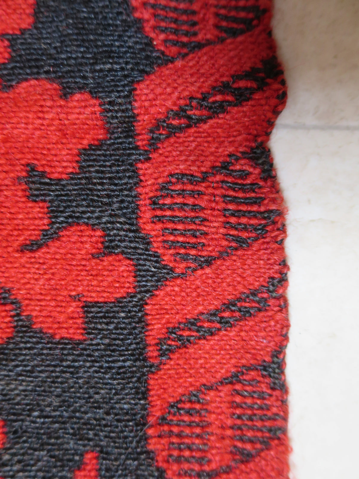 Detailed view of the dense selvedge weave on a heavy weight 2.2 kg antique wool double-weave coverlet blanket.