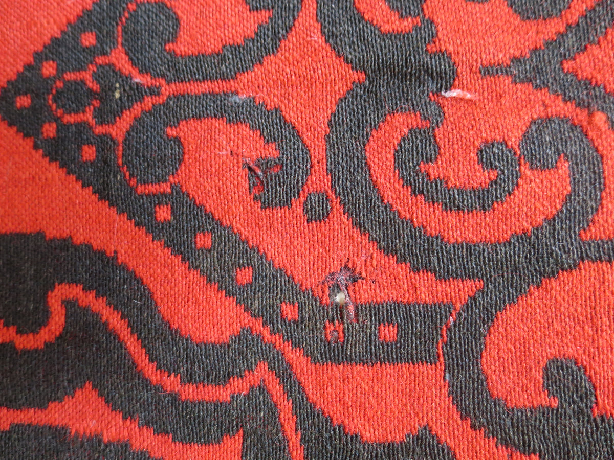 Close up texture of the hand-spun wool fibers and weave structure on a mid-19th-century American folk art textile.