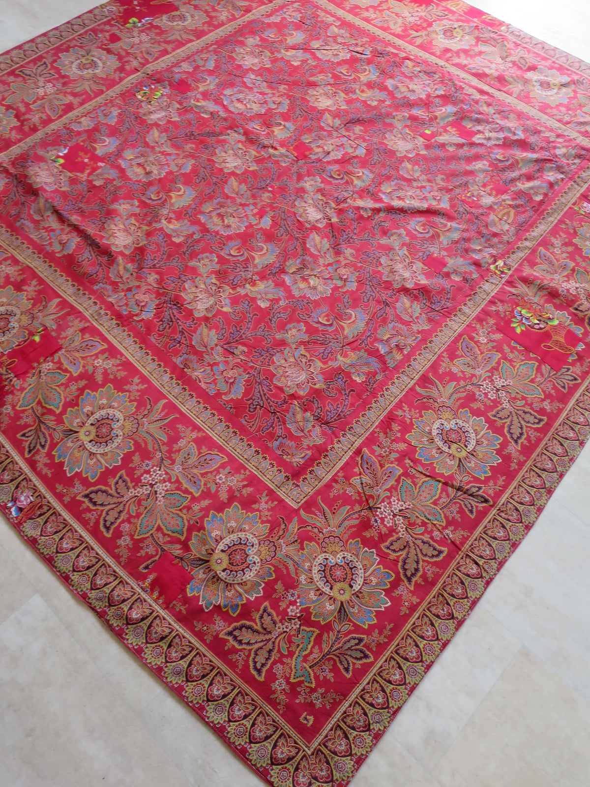 Madder-red Indienne revival print on the quilt's reverse