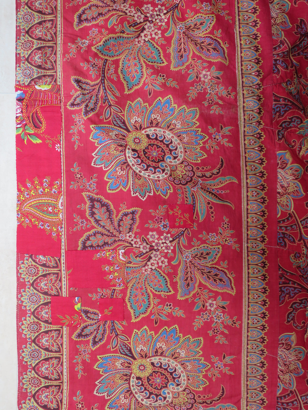 Period patch repair on the quilt's madder chintz reverse