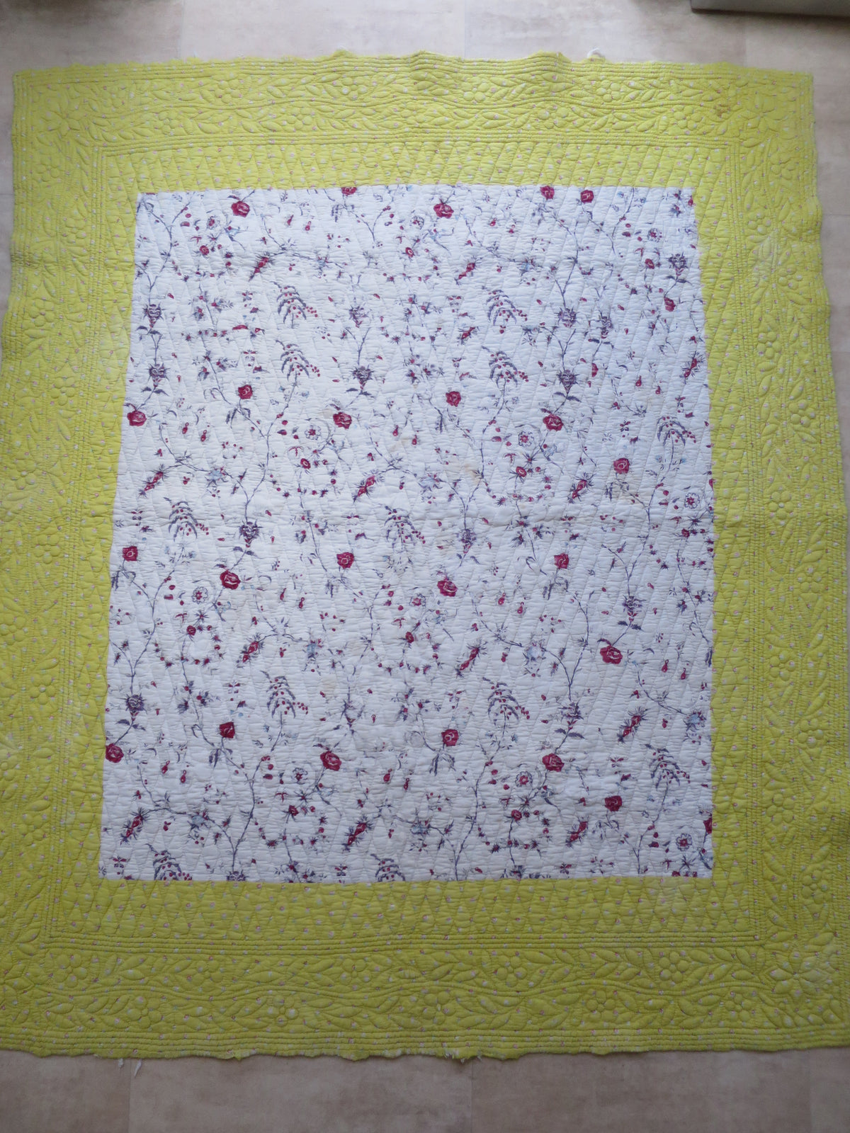 18th-century French panel quilt with chintz centre print and quilted, trapunto sulphur-yellow border