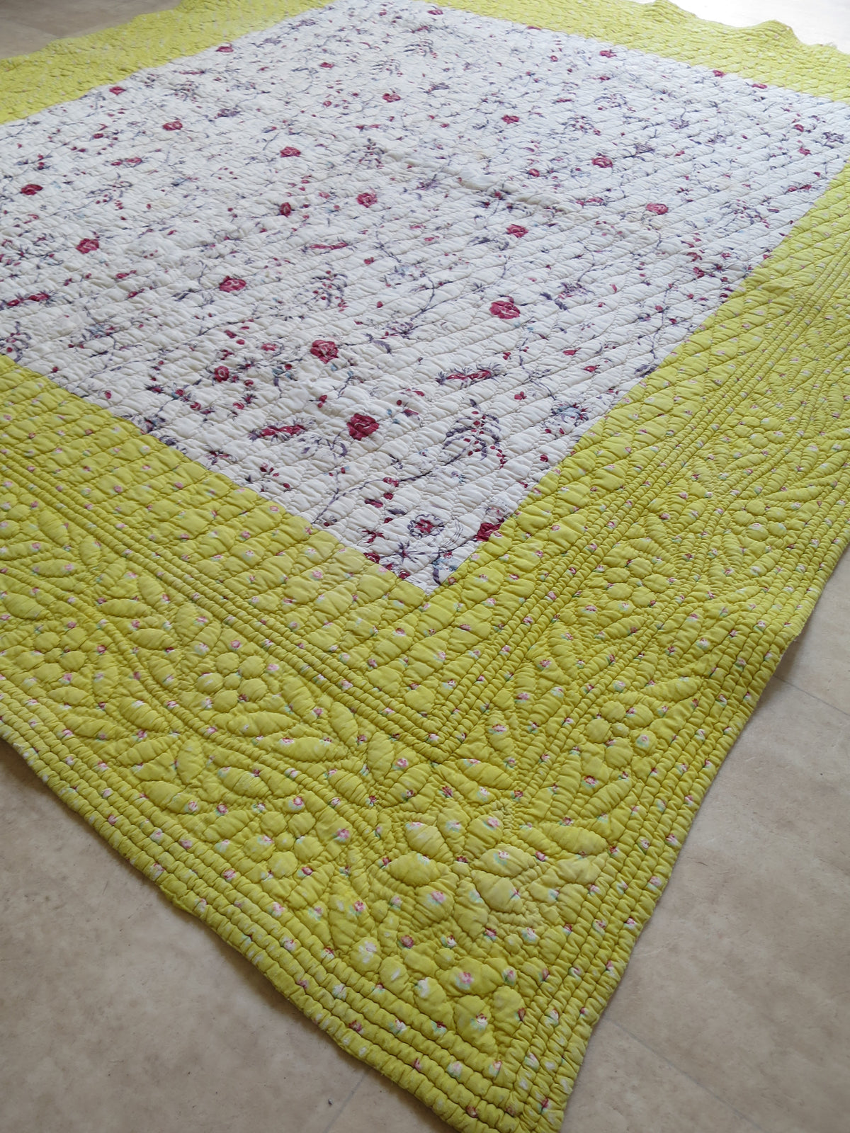18th-century French panel quilt with chintz centre print and quilted, trapunto sulphur-yellow border