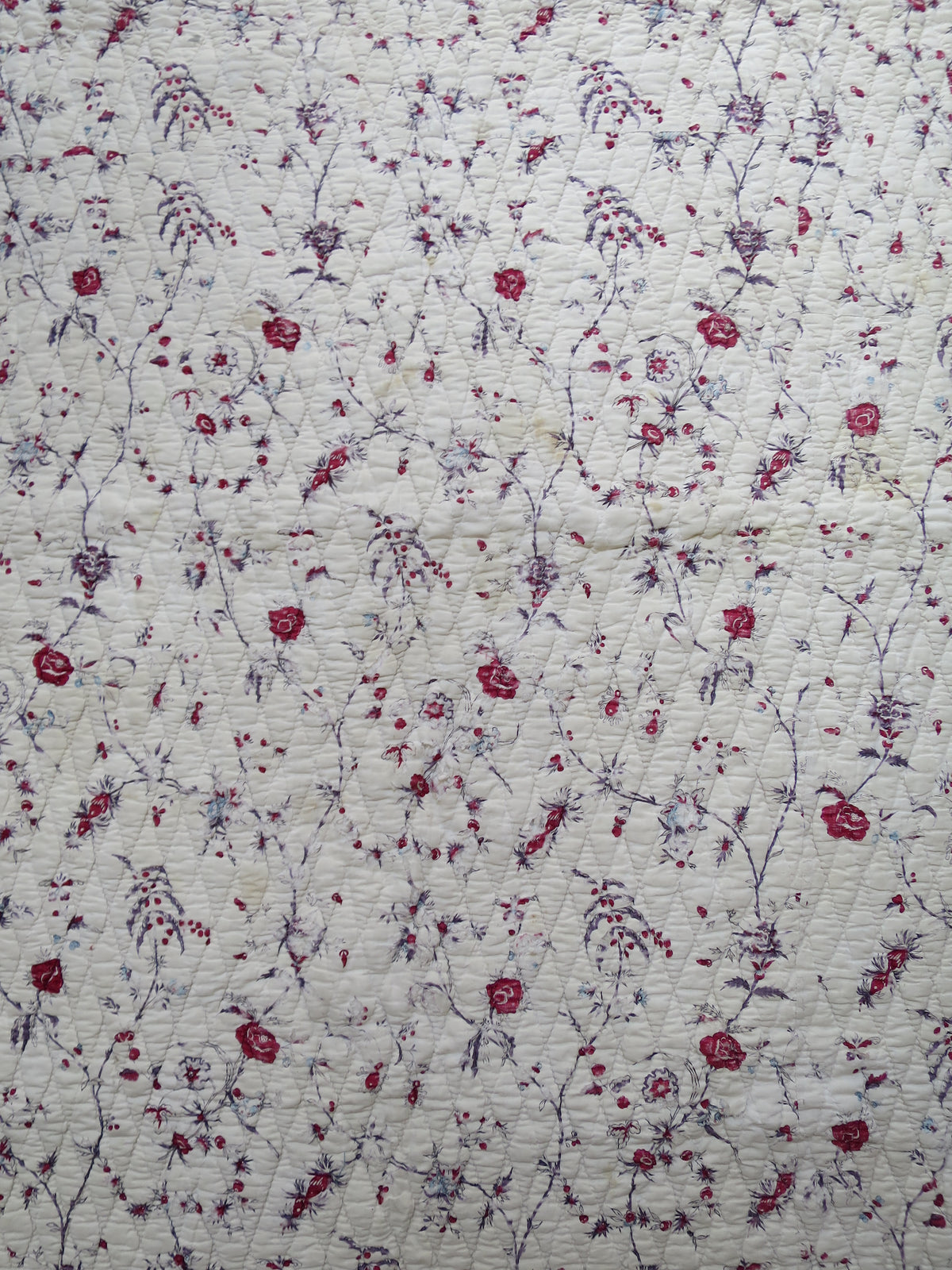 Block-printed floral chintz centre panel of the quilt