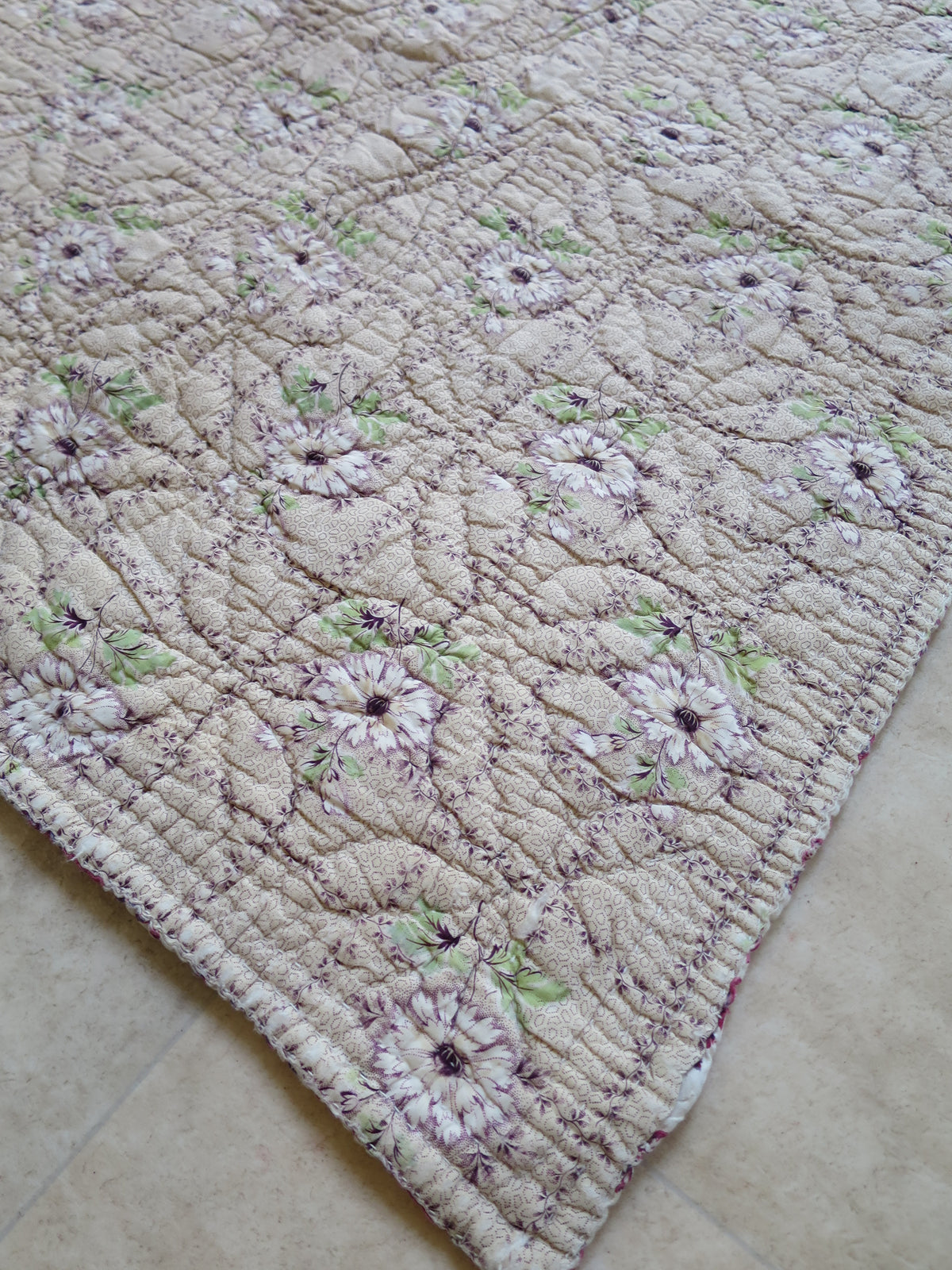 Quilted border on the floral reverse, showing floral motifs