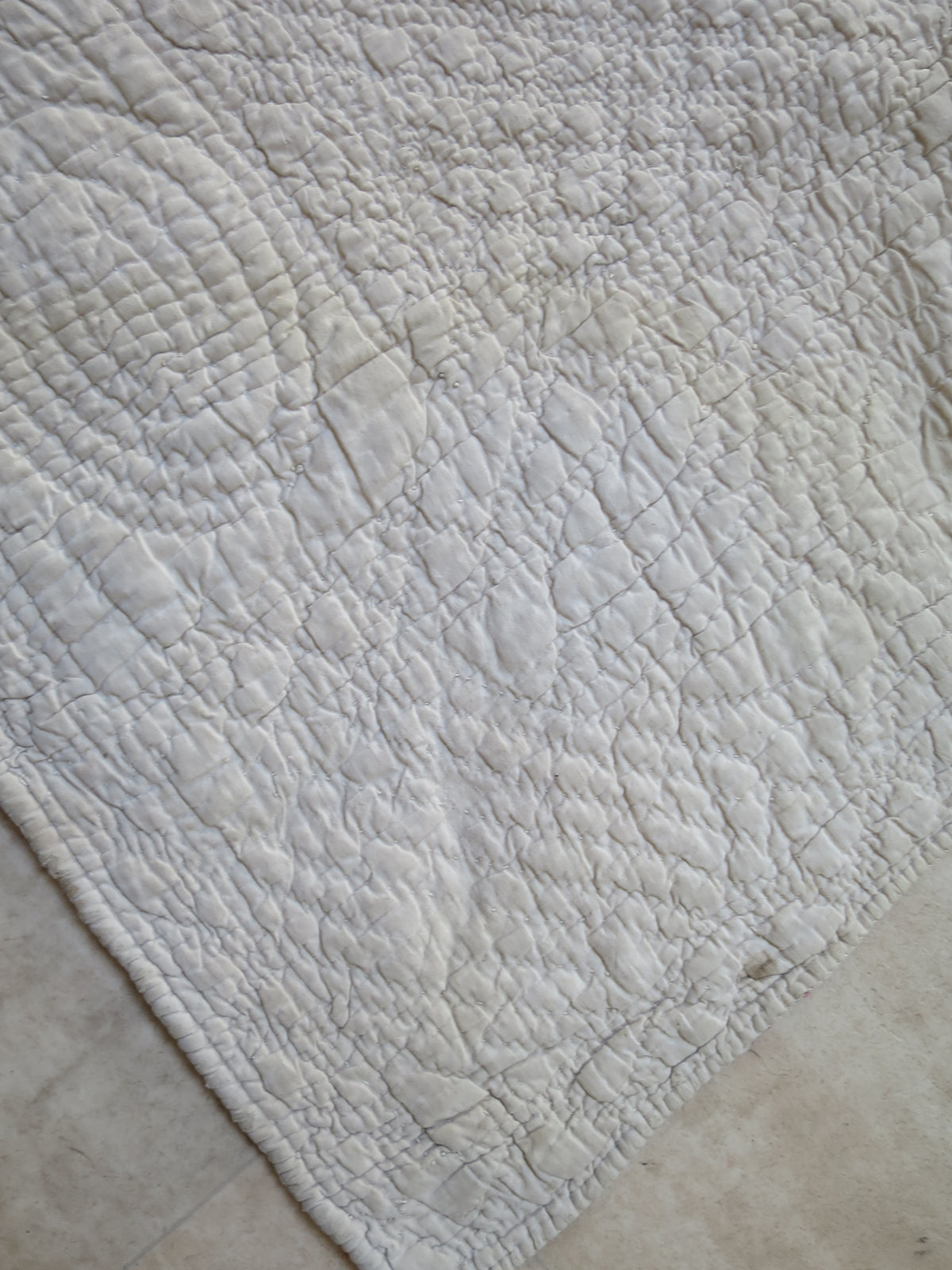 Detail of the hand-quilted border on the reverse of the French Provençal piqué quilt.