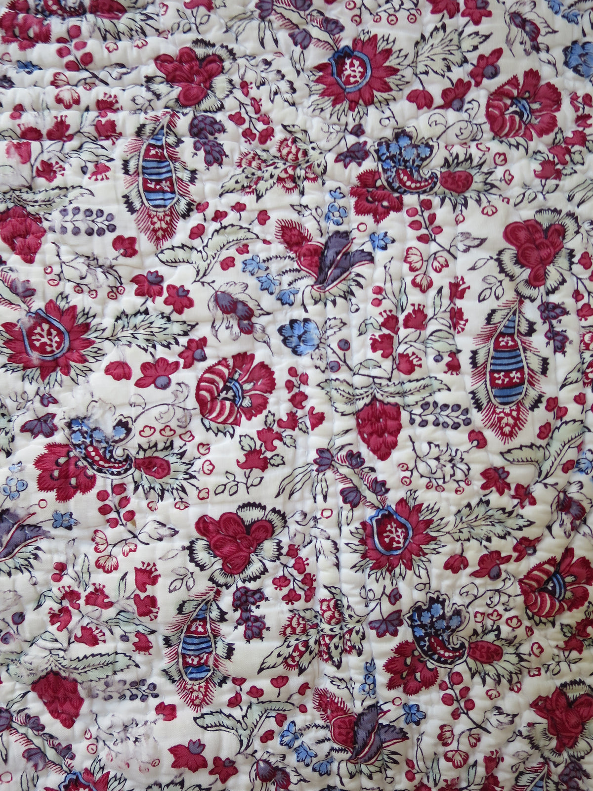 Close-up of woodblock-printed indienne botanical print with penciled blue highlights, late 18th-century French textile