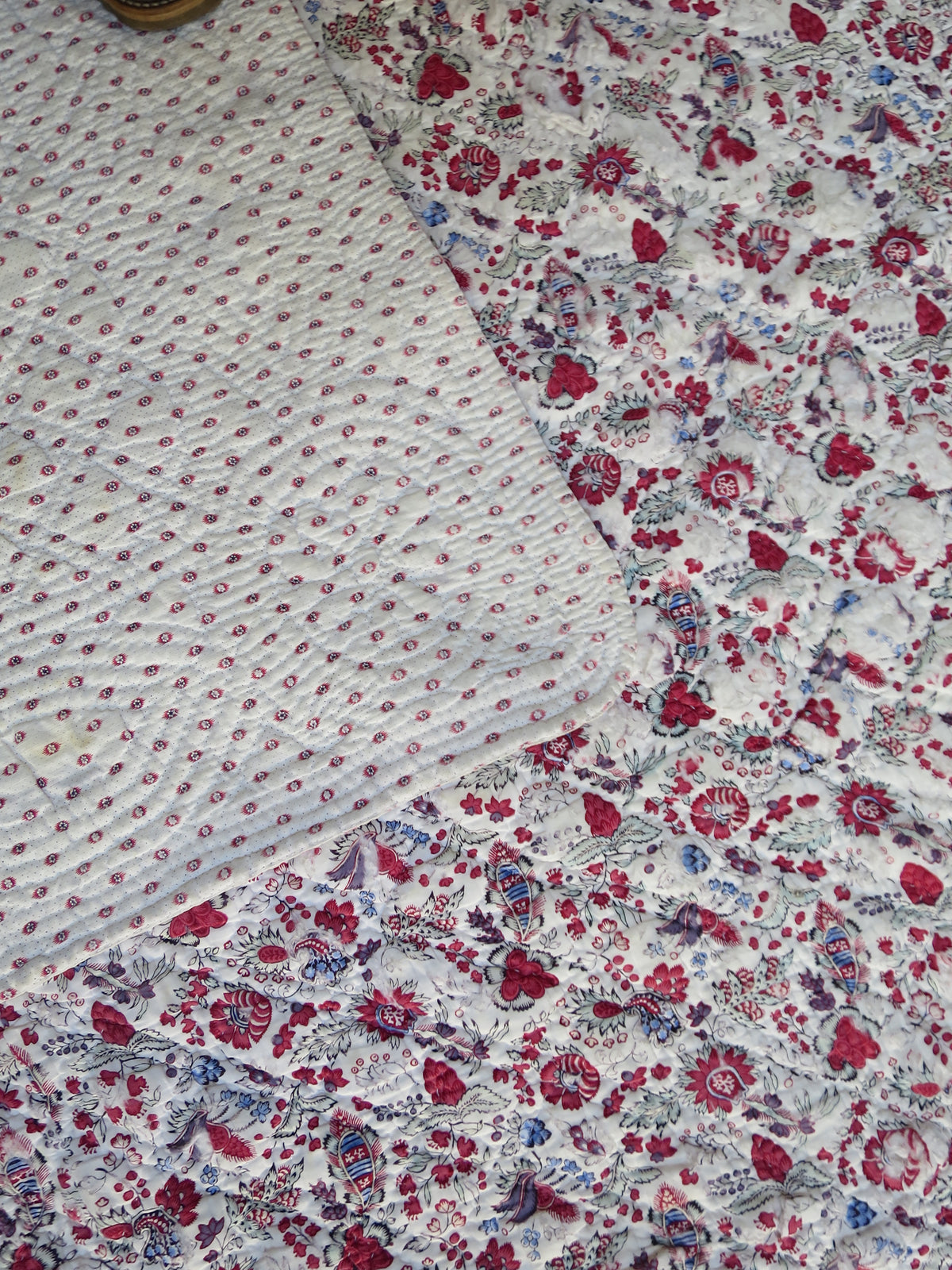 Late 18th-century French reversible piqué quilt showing both faces — indienne botanical print with penciled blue highlights (front) and mignonette block-print with picotage ground (reverse), c.1775–1790