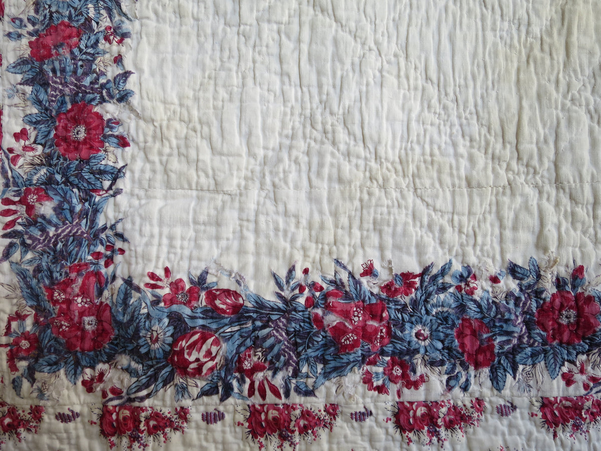 Floral print on the quilt’s scarf panel, with a repeat of roses, foxgloves and tulips.