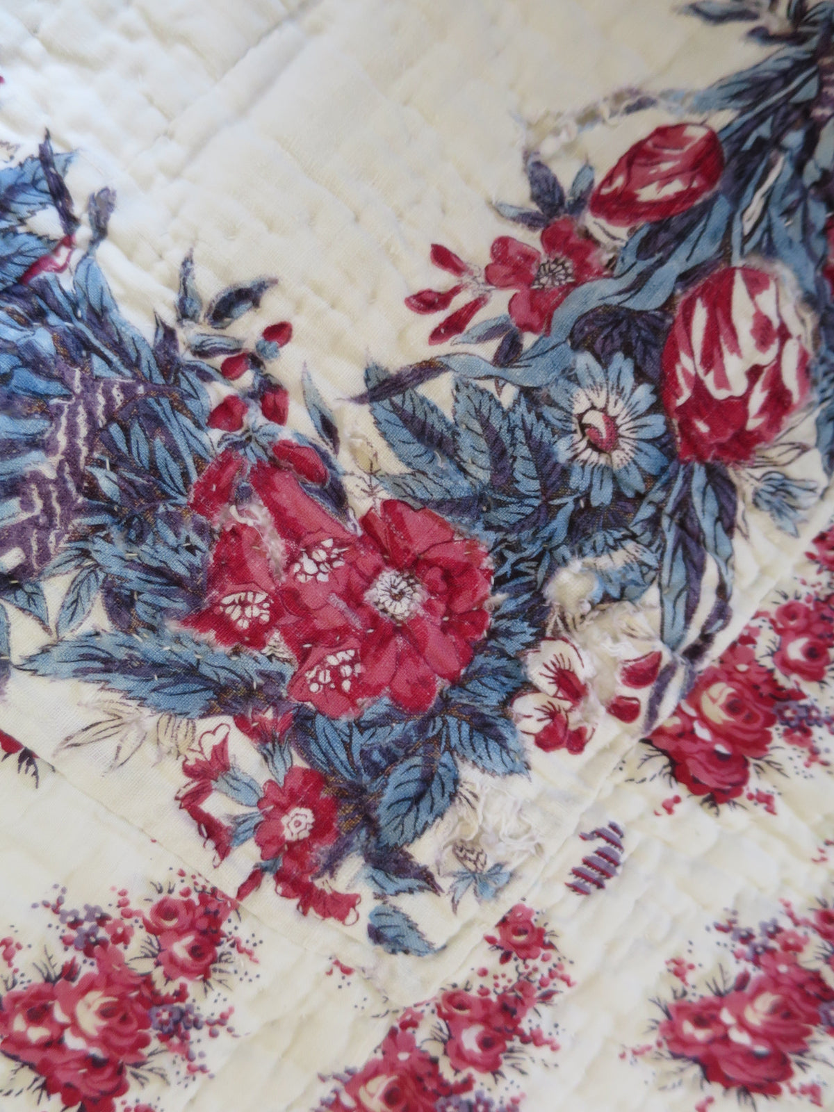 Detail of the scarf’s corner print on the front of the early 19th-century French quilt.