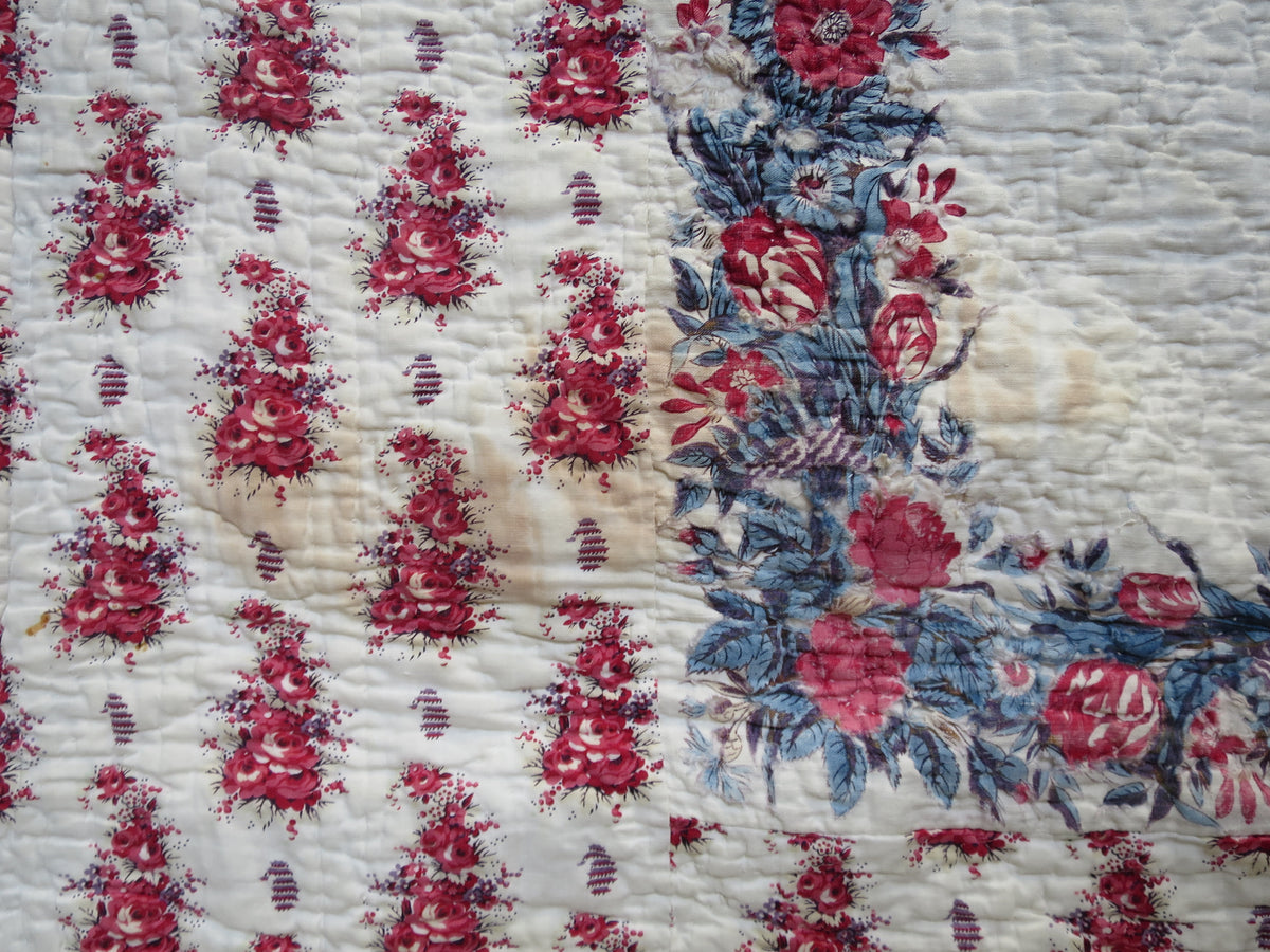 Water marking visible on the printed front of the French reversible quilt.