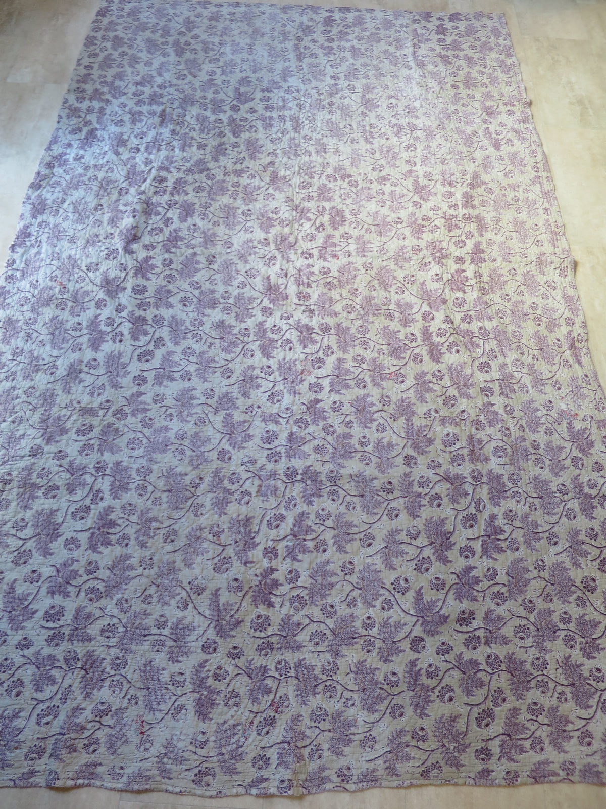 Front of the 18th-century part quilt, plum-purple block-printed floral chintz