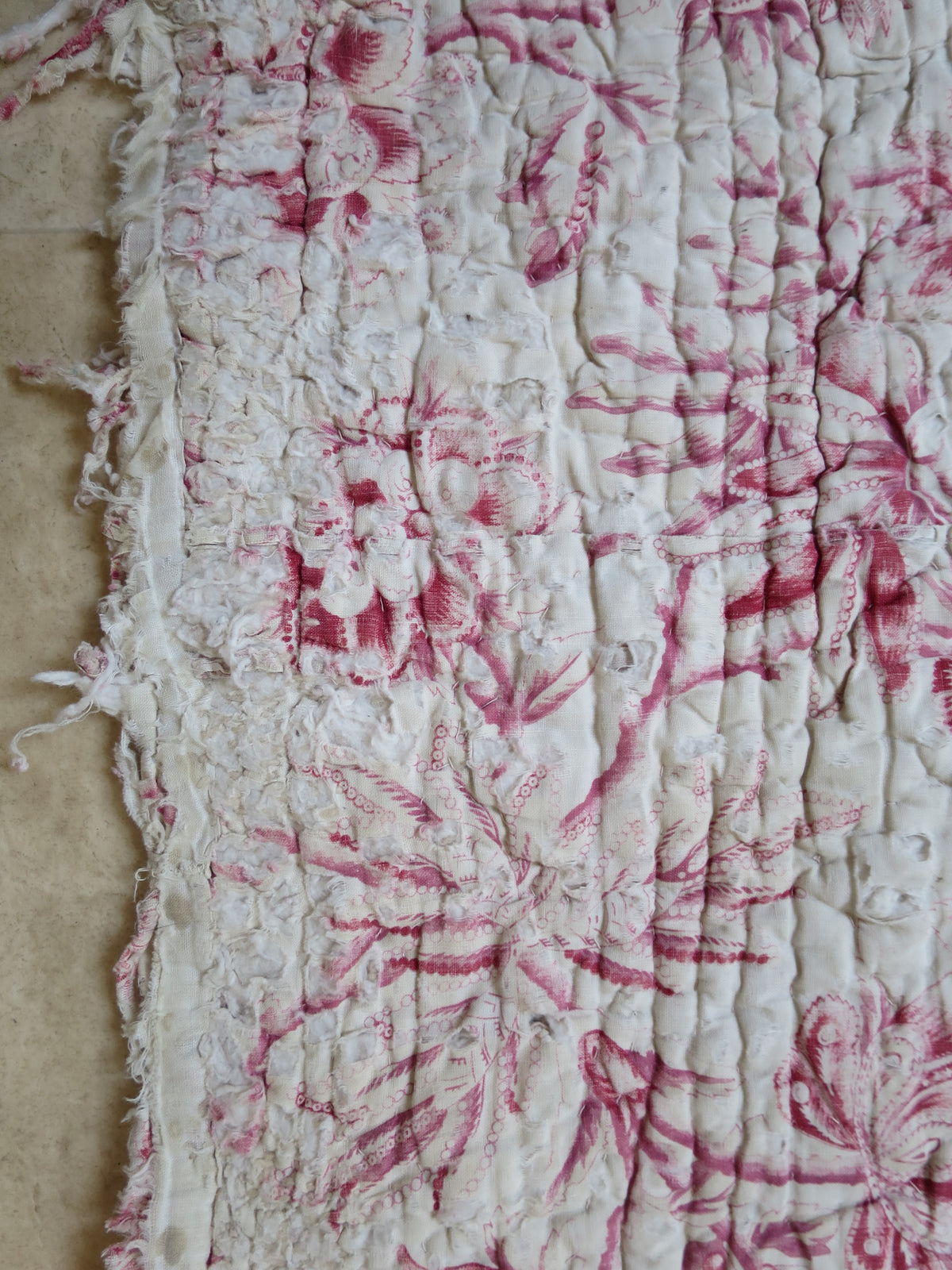 Area of wear on the quilt front, showing genuine age