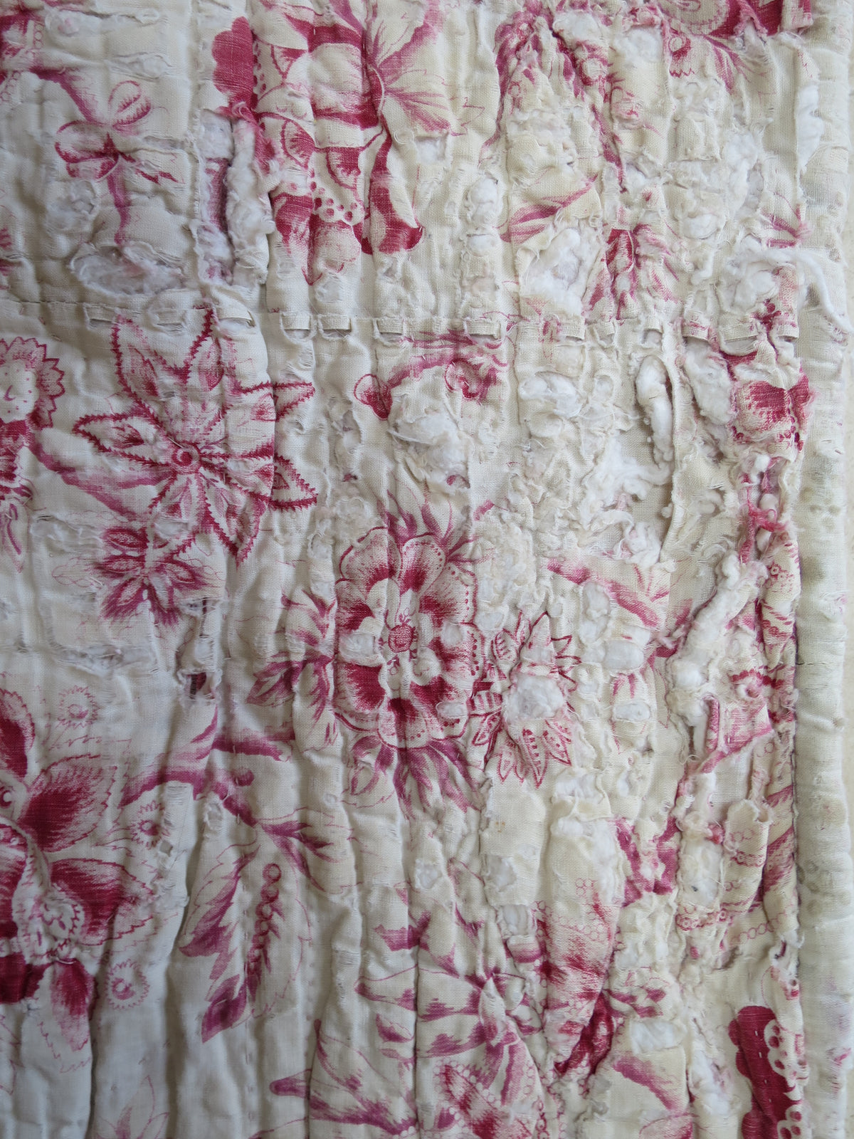 Area of wear on the quilt front, showing genuine age