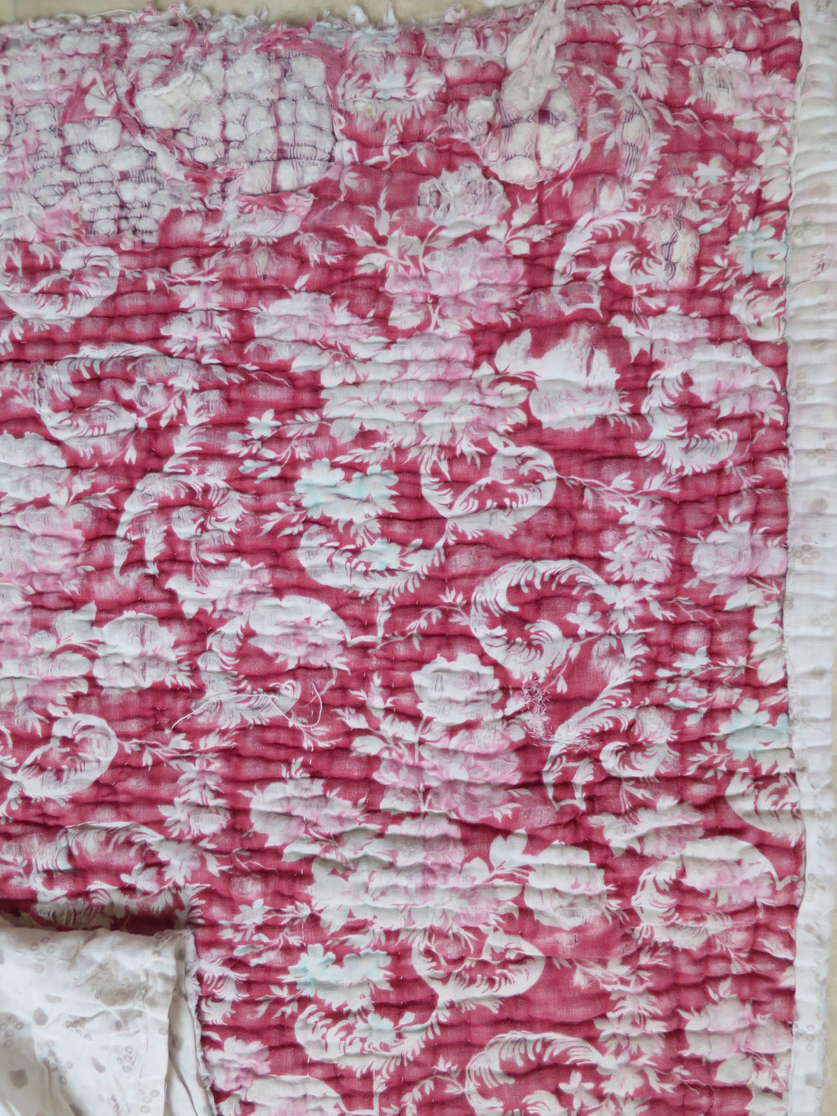 Printed fabric on the second backing layer of the quilt