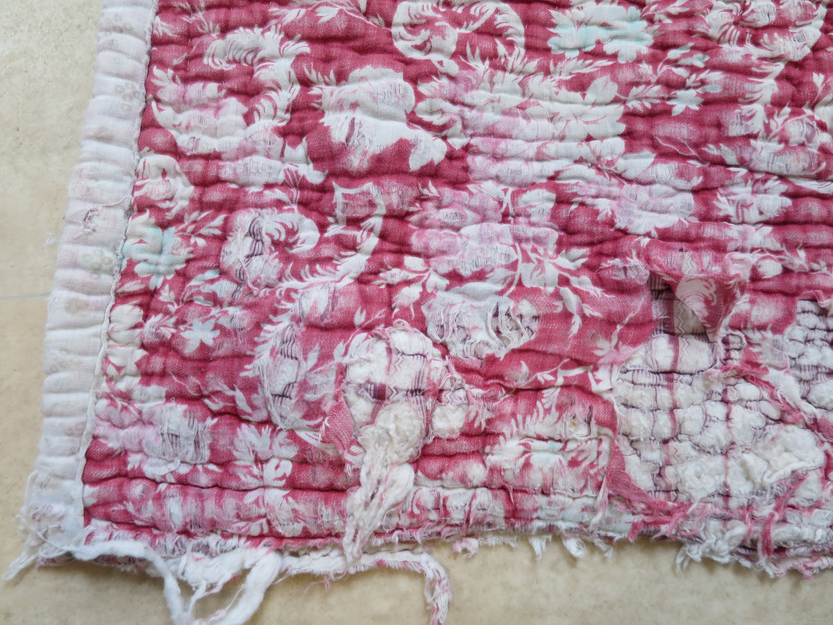 Quilt edge showing all three backing layers and generations of wear