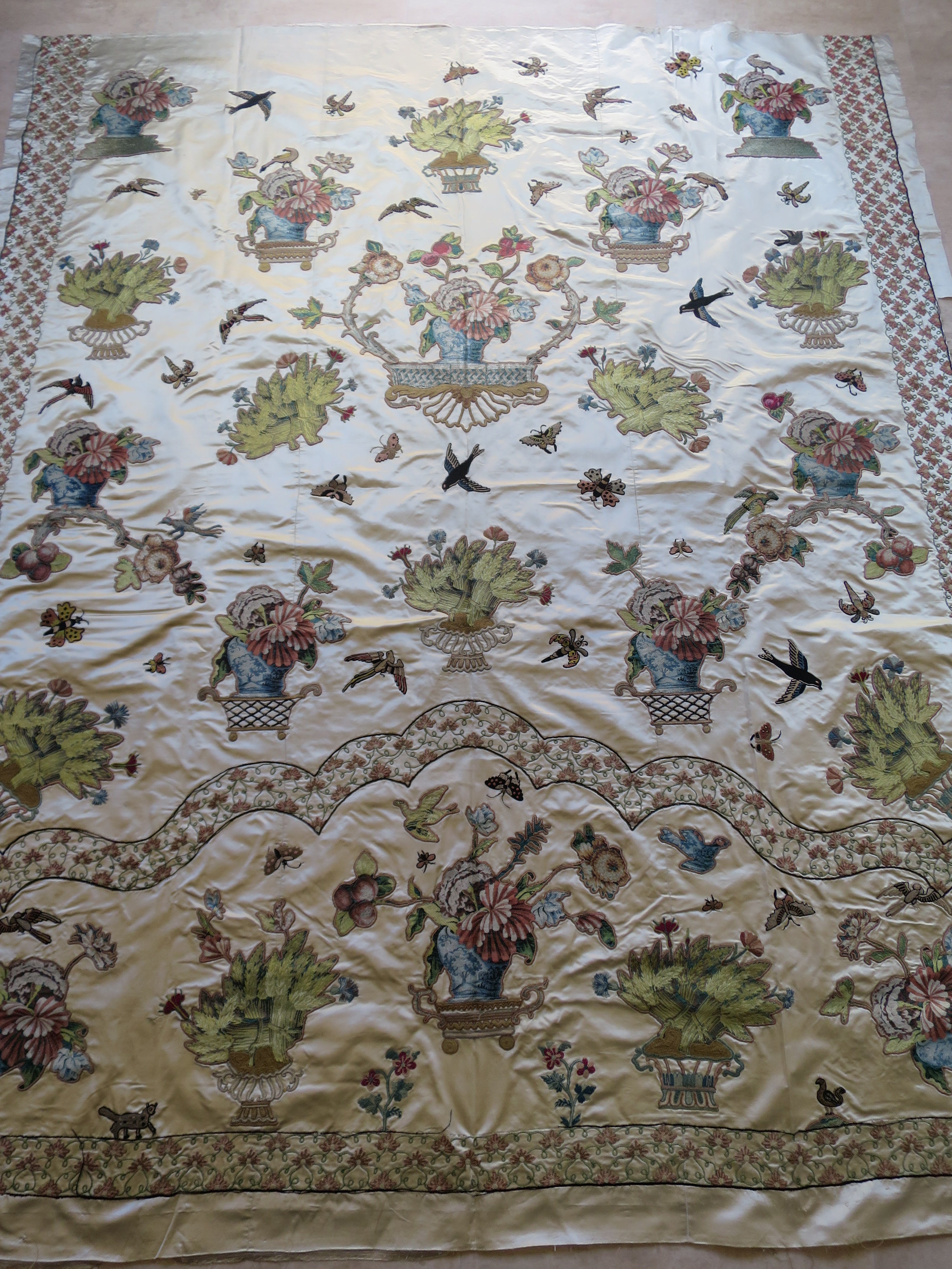 Full view of an English Georgian silk coverlet, c. 1780–1810, with cut lampas silk appliqués and later embroidery.