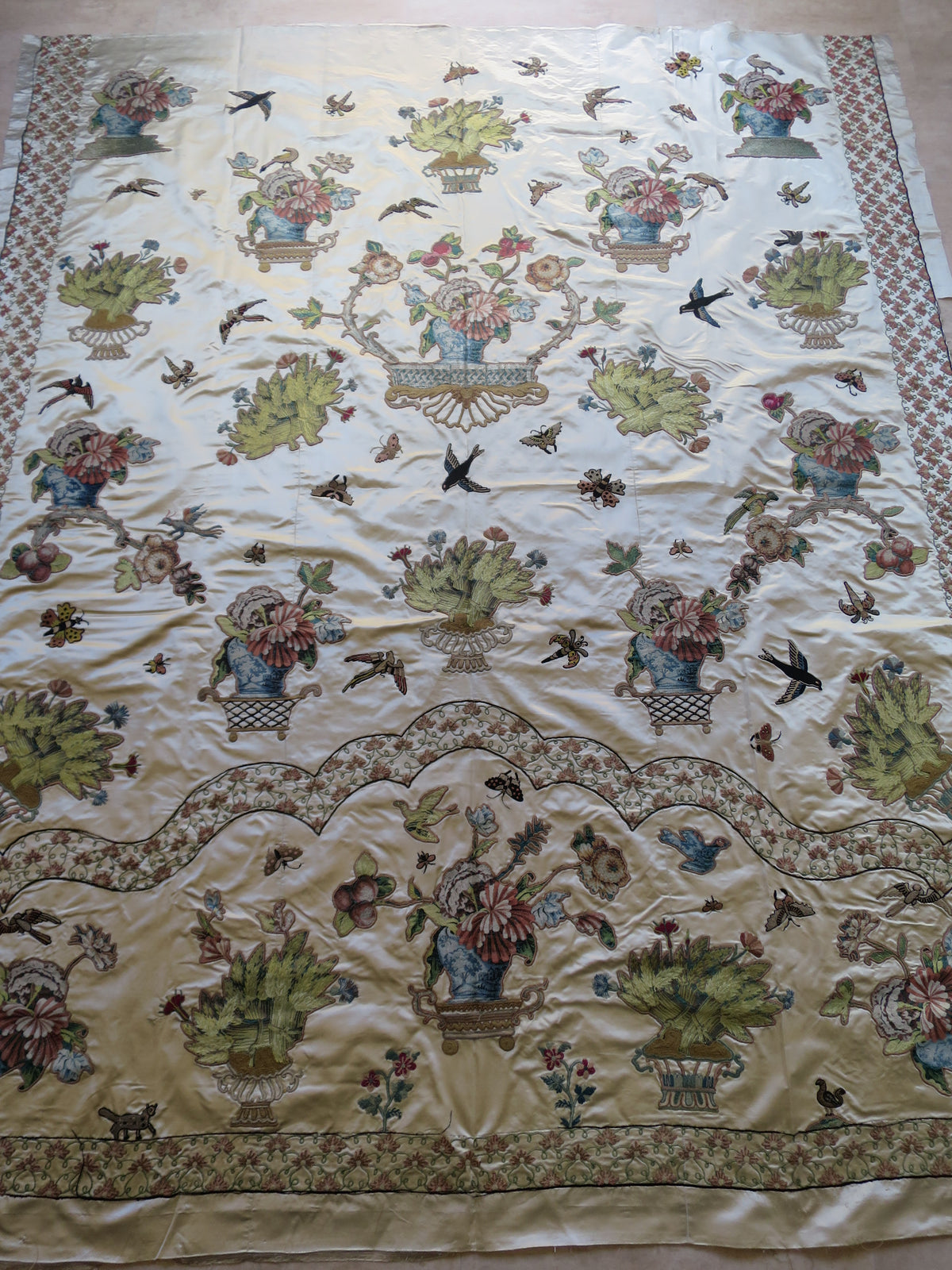 Full view of an English Georgian silk coverlet, c. 1780–1810, with cut lampas silk appliqués and later embroidery.