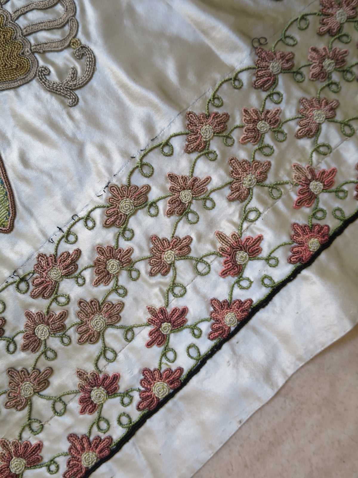 Border embroidery detail on the English silk coverlet.