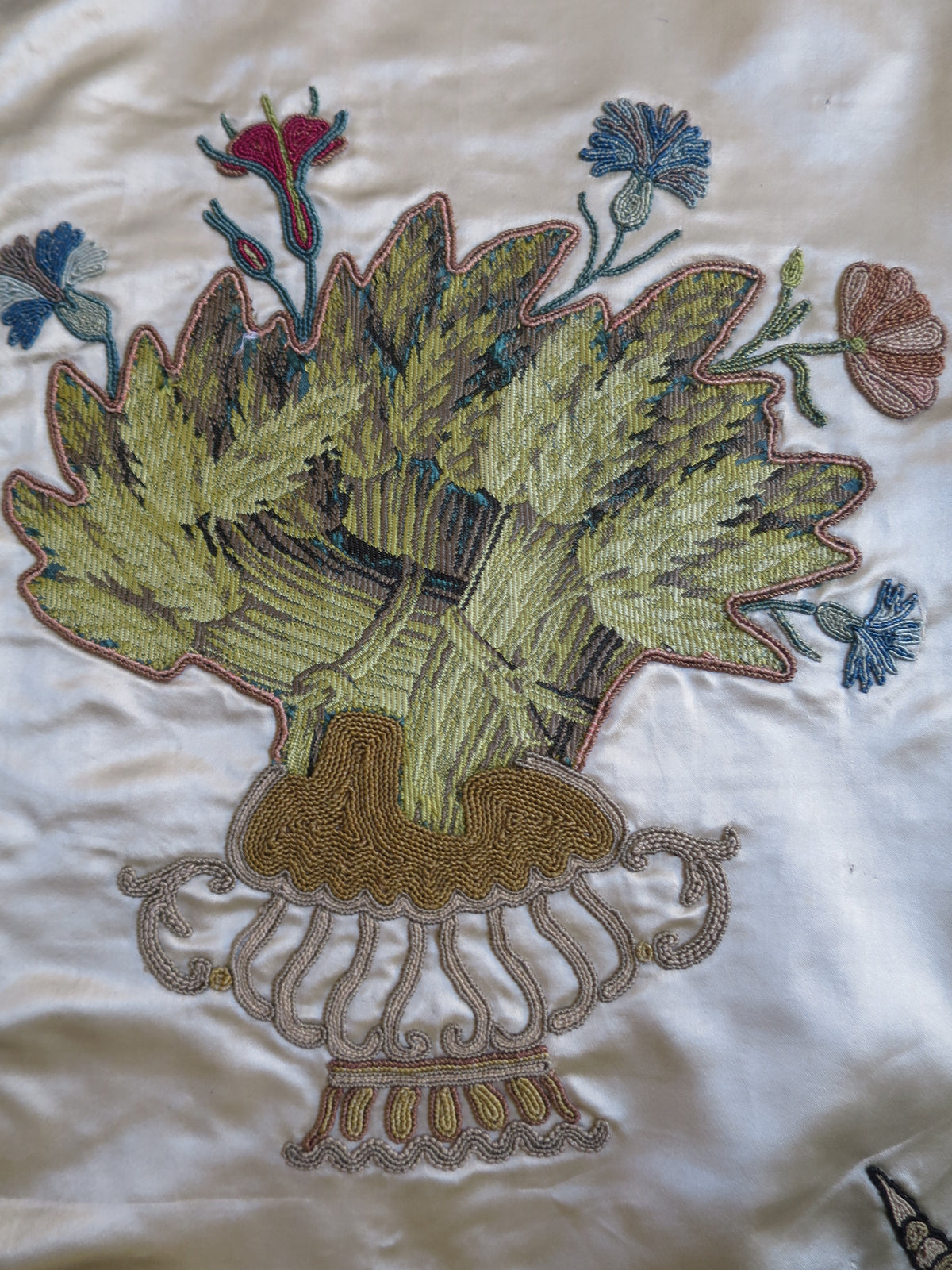 Close view of a cut lampas silk appliqué motif on the English coverlet 