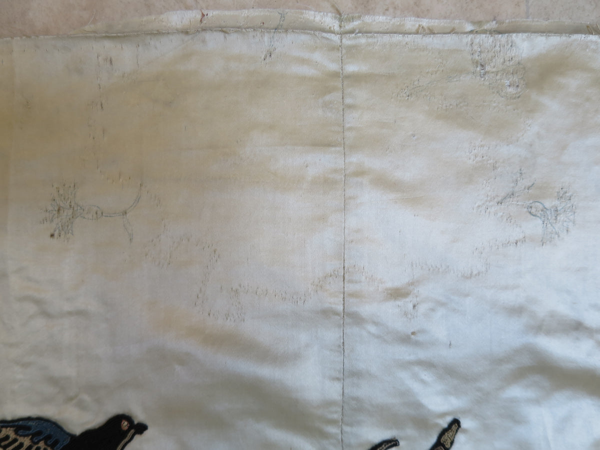 Top edge showing design tracings and exposed stitch lines where the embroidery has been unpicked.