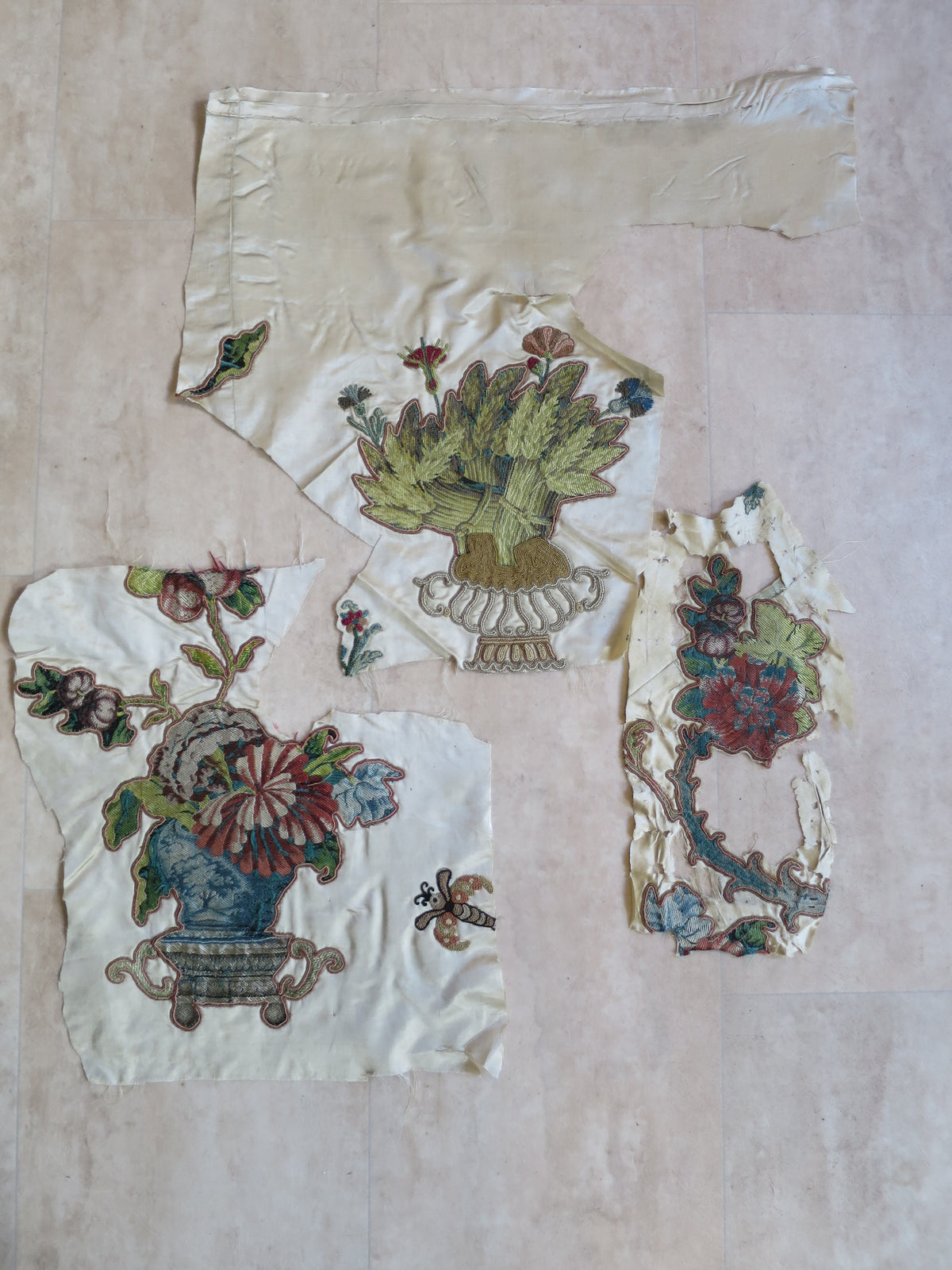 Detached appliqué fragments associated with the coverlet’s later restoration.